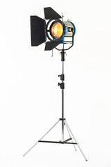 Professional film warm lighting, stage light with barndoors on a stand isolated on a white background