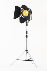 Professional film warm lighting, stage light with barndoors on a stand isolated on a white background