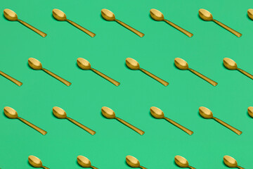 pattern with spoons on green surface
