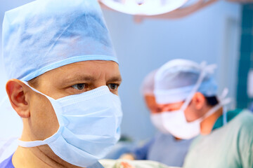Male doctor operation room with his team - 486917210
