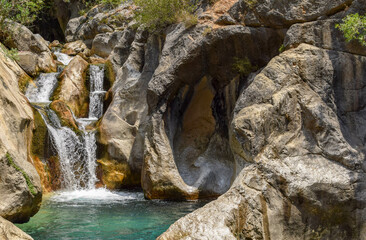 Fototapeta premium Cascade of waterfalls in the mountains of southern Turkey on a summer day.