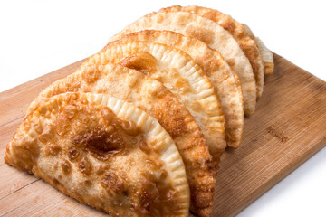 caucasian fried chebureks on a plate. On a white background