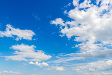 Naklejka na ściany i meble White fluffy clouds on blue sky. Heaven background