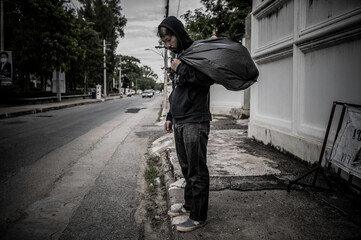 Asian man is homeless at the side road,A stranger has to live on the road alone because he has no family.