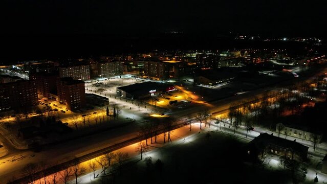 Aerial footage of frozen City at night in the snow. Night city landscape.