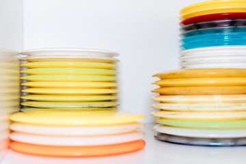 stack of colorful discs and frisbees