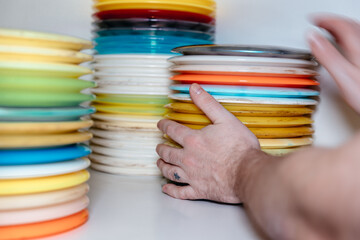 hand picking up disc golf discs