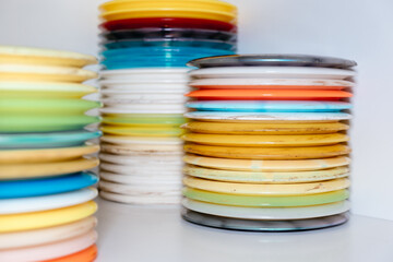 stack of colorful discs and frisbees in stock