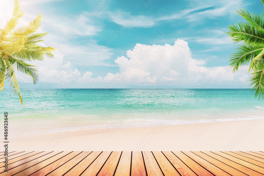 Poster blur tropical beach with bokeh sun light wave and palm tree on empty old wood table abstract backgro