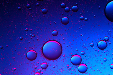 abstract background. drops of oil on water, blue and red. macro