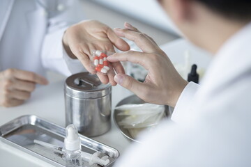 Close up of doctor holding pills