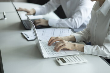 Business people using laptop in meeting