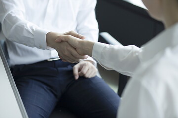 Obraz premium Close-Up Of Business People Shaking Hands In Meeting