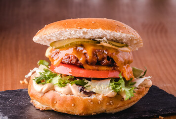 Vegetarian burger imitation meat, with tomato, cheese, pickle and sauce