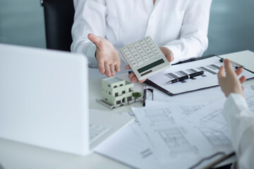 Business people using calculator in meeting