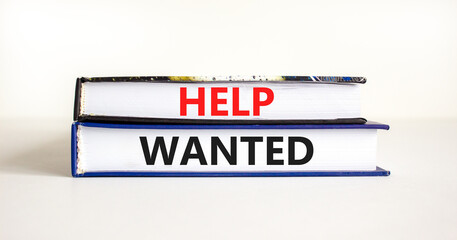 Help wanted and support symbol. Concept words Help wanted on books on a beautiful white table white background. Business support and help wanted concept, copy space.