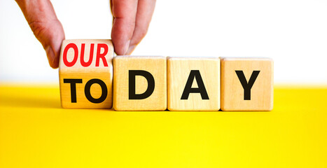 Today is our day symbol. Businessman turns the wooden cube and changes concept words Today to our...