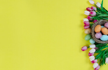 Right border of tulip flowers with nest and eggs on a bright yellow background for a happy Easter holiday season