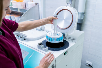 Laboratory assistant works with microwave hybrid tissue processor at the modern laboratory.