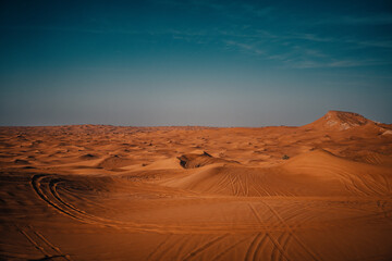 Fototapeta na wymiar Sundown in desert. Red sand desert background.