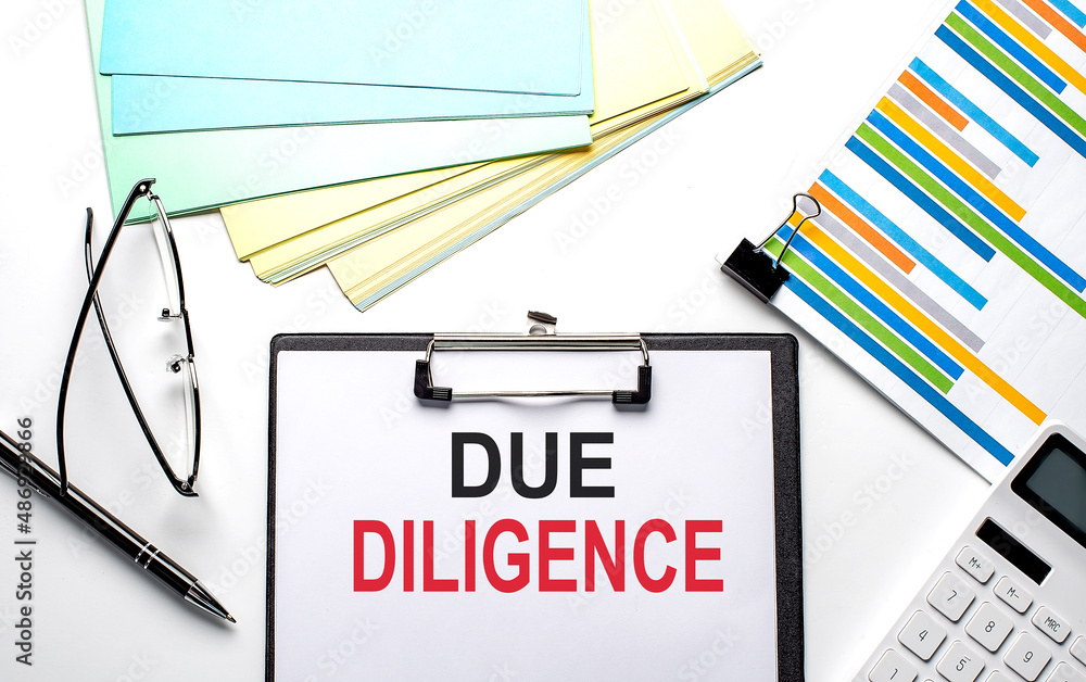 Poster due diligence text on paper sheet with chart,color paper and calculator