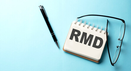 RMD text written on a notepad on the blue background