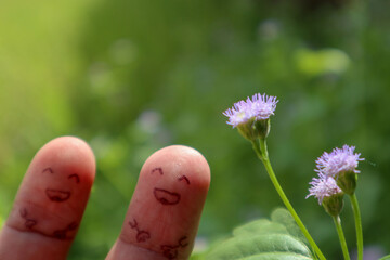 two finger and flower with emoticon smile as background 