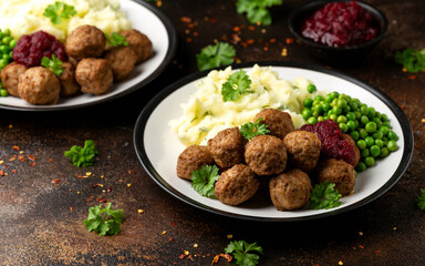 Homemade Swedish Meatballs with cranberry relish Sauce, potato mash and peas
