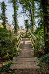 Wooden bridge over a dyke on a rural footpath in the Norfolk countryside