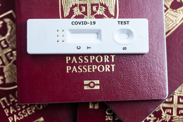 Rapid serology COVID-19 test cassette on red biometric passport