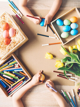 Children prepare for easter. Kids painting easter eggs. Easter background, flat lay, top view.