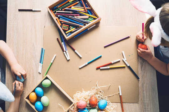 Children prepare for easter. Kids painting easter eggs. Easter background, flat lay, top view.