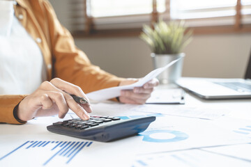 person using calculator calculating tax refund on the table