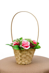 Fototapeta na wymiar Basket with fragrant handmade soap in the form of roses and raspberries. White background, isolated.