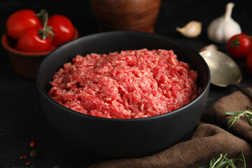 Fresh minced meat in bowl on table, closeup