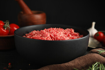 Fresh minced meat in bowl on table, closeup