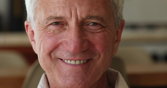 Cropped close up face view 55s man smile look at camera feel happy. Medical insurance cover for older citizen, portrait of carefree mature male. Dental, eye vision check up clinic services ad concept