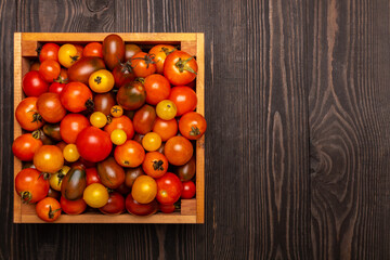 Fototapeta na wymiar tomatoes in a box on a wooden table top view