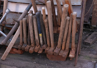 old hammers. close-up showing old rusty metal and brass parts in bulk for decoration or collection, sold at a flea market or garage for an antique collection. Rusty keys and tools for restoration