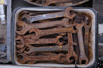 
close-up showing old rusty metal and brass parts in bulk for decoration or collection, sold at flea market or garage for antique collection. Rusty keys and tools for restoration