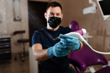 dentist holding a dental air cleaner
