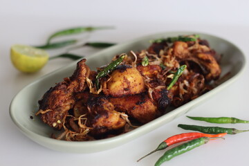Spicy chicken fry garnished with caramelised onions