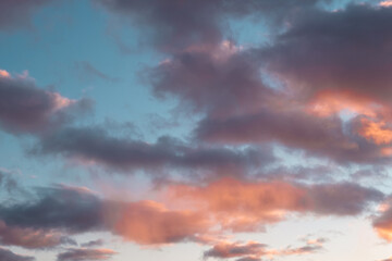 Blue-pink clouds in the light of the setting sun