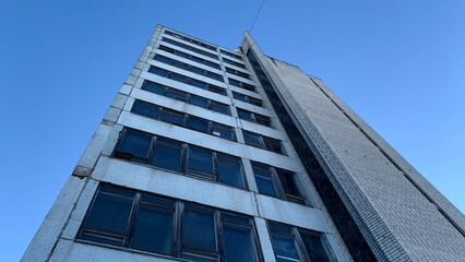 Fototapeta premium High-rise abandoned office building belonging to an old factory