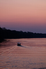 Beautiful red and orange sunrise at Rio Madre de Dios near Puerto Maldonado in the Tambopata National Park in the Amazonas region (Peru, South America)