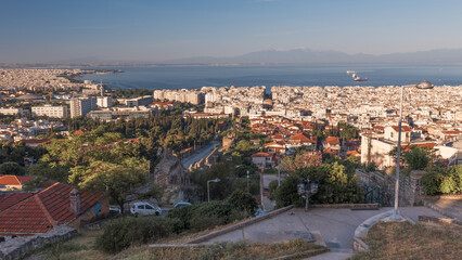 Fototapeta na wymiar Cityscape with downtown, living neighborhoods, sea and mountains in a haze, Thessaloniki, Greece