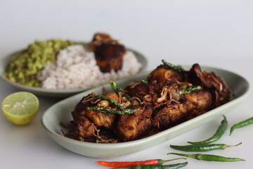 Spicy chicken fry garnished with caramelised onions, served as side dish of kerala rice meal