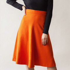 Young woman wearing an orange midi skirt and black blouse isolated on white background.