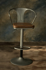 round chair with one leg and upholstered seat