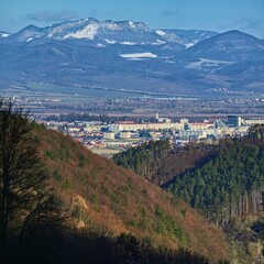 Fototapeta na wymiar The Slovak town of Dubnica nad Vahom with the Vrsatec mountains in the background bathed in sunshine in one winter morning